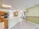 Bright, eat-in kitchen with tile floors, wooden cabinets, and sliding glass doors at 451 Acacia Tree Way, Kissimmee, FL 34758