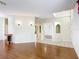 Open-concept living room with hardwood floors and neutral wall paint at 451 Acacia Tree Way, Kissimmee, FL 34758