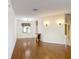 Bright, open living space with beautiful hardwood floors and stylish wall sconces at 451 Acacia Tree Way, Kissimmee, FL 34758