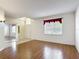 Well-lit living area with hardwood floors, a sliding mirrored closet, and large window at 451 Acacia Tree Way, Kissimmee, FL 34758