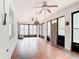Enclosed sunroom featuring tile flooring, ceiling fans and access to the backyard at 451 Acacia Tree Way, Kissimmee, FL 34758