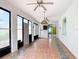 Enclosed sunroom with tile flooring, ceiling fans and sliding glass doors at 451 Acacia Tree Way, Kissimmee, FL 34758