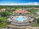 Aerial view of the clubhouse with red tile roofs with the pool, and palm trees at 512 Viola Dr, Davenport, FL 33837