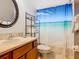 Cozy bathroom featuring a beach-themed shower curtain and wood vanity at 512 Viola Dr, Davenport, FL 33837
