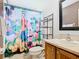 Bright bathroom features a themed shower curtain and a single vanity at 512 Viola Dr, Davenport, FL 33837