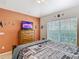 Inviting bedroom features themed wall decor and a large window at 512 Viola Dr, Davenport, FL 33837