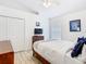 Cozy bedroom with wood-look flooring, ample natural light, and a closet for storage at 512 Viola Dr, Davenport, FL 33837