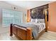 Comfortable bedroom features light wood flooring, a mural, and a large window at 512 Viola Dr, Davenport, FL 33837