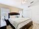 Bright bedroom with vaulted ceiling features light wood flooring and a ceiling fan at 512 Viola Dr, Davenport, FL 33837