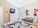 Themed bedroom featuring two beds and a cartoon TV at 512 Viola Dr, Davenport, FL 33837