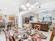 Elegant dining room with a glass table, and a view into the kitchen and living room at 512 Viola Dr, Davenport, FL 33837