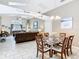 Open-concept dining area with a modern chandelier, tile floors, and a view into the living room at 512 Viola Dr, Davenport, FL 33837