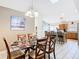 Dining room area showcases a glass table, and provides seamless transition to the kitchen at 512 Viola Dr, Davenport, FL 33837