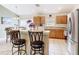 Bright kitchen with light wood cabinets, stainless steel appliances, and a breakfast bar at 512 Viola Dr, Davenport, FL 33837