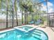 Screened-in pool area with lounge chairs and lush landscaping at 512 Viola Dr, Davenport, FL 33837