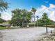 Outdoor sand volleyball court with lake view and lush greenery at 512 Viola Dr, Davenport, FL 33837