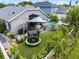 Aerial view of backyard with pool, trampoline, landscaping, patio, and fenced yard at 545 Hardwood Cir, Orlando, FL 32828