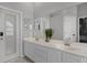 Bright bathroom featuring double sinks, large vanity mirror, and tiled floor with a decorative plant at 545 Hardwood Cir, Orlando, FL 32828
