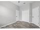 A bright bedroom featuring multiple doors, closets, ceiling fan and laminated floors at 545 Hardwood Cir, Orlando, FL 32828