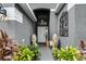 Welcoming front entryway with lion statues, decorative metalwork, and lush landscaping at 545 Hardwood Cir, Orlando, FL 32828
