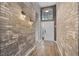 Inviting entryway with brick walls, hardwood flooring, and a modern front door at 545 Hardwood Cir, Orlando, FL 32828