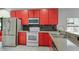 Modern kitchen features sleek stainless steel appliances and red cabinets at 545 Hardwood Cir, Orlando, FL 32828