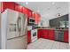 Modern kitchen features sleek stainless steel appliances and red cabinets at 545 Hardwood Cir, Orlando, FL 32828