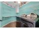 Laundry room with modern appliances, overhead shelves, and bright decor at 545 Hardwood Cir, Orlando, FL 32828