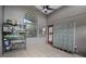 Enclosed sunroom with a large storage unit, tile floors, and multiple windows for ample natural light at 545 Hardwood Cir, Orlando, FL 32828
