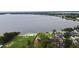Waterfront property featuring a private beach, lush greenery, and a lake view from an elevated perspective at 5529 Hansel Ave, Orlando, FL 32809