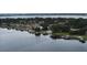 A scenic lake view featuring waterfront homes, private docks, and lush green landscapes along the shore at 5529 Hansel Ave, Orlando, FL 32809