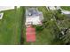 Aerial view of home showcasing roof, patio, backyard, and ample parking space at 5529 Hansel Ave, Orlando, FL 32809