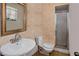 Small bathroom featuring a sink, toilet, and shower with sliding glass doors at 5812 Viking Rd, Orlando, FL 32808