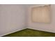 Textured-wall bedroom with a single window and simple curtain and green carpet at 5812 Viking Rd, Orlando, FL 32808