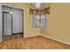 Bright dining room featuring beautiful hardwood floors, a classic chandelier, and natural light from the window at 5812 Viking Rd, Orlando, FL 32808