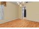 Bright dining room with hardwood floors, a stylish chandelier, and doorway leading to the kitchen area at 5812 Viking Rd, Orlando, FL 32808