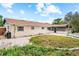 Backyard view of house and enclosed patio, offering ample green space and a tranquil setting at 5812 Viking Rd, Orlando, FL 32808