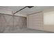 Spacious garage featuring neutral walls and a metal roll-up door for secure parking and storage at 5812 Viking Rd, Orlando, FL 32808