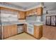 Well-lit kitchen features wood cabinets, modern appliances, and an open layout with views into the dining area at 5812 Viking Rd, Orlando, FL 32808