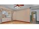 Bright, open living room features updated flooring, a ceiling fan and a large window at 5812 Viking Rd, Orlando, FL 32808