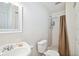 Bright bathroom featuring a white vanity, toilet, and shower with a neutral-colored curtain at 6663 Nw 60Th St, Ocala, FL 34482