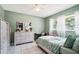 Inviting bedroom with a dresser, desk area, neutral-toned decor, and bright natural light at 6663 Nw 60Th St, Ocala, FL 34482