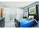 Cozy bedroom featuring a comfortable bed, dresser, and natural light from the window at 6663 Nw 60Th St, Ocala, FL 34482
