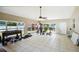 Spacious bonus room with exercise equipment, tile flooring, and large windows overlooking the backyard at 6663 Nw 60Th St, Ocala, FL 34482
