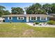 Charming blue single-story home featuring a well-manicured lawn and inviting curb appeal at 6663 Nw 60Th St, Ocala, FL 34482