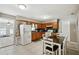 Spacious kitchen with ample wooden cabinetry, a modern refrigerator, and a dining area at 6663 Nw 60Th St, Ocala, FL 34482