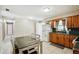 Bright kitchen with ample cabinet space, white appliances, and a table with seating at 6663 Nw 60Th St, Ocala, FL 34482