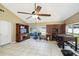 Open-concept living room with a foosball table, tile floors, and access to natural light at 6663 Nw 60Th St, Ocala, FL 34482
