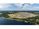 A community bordering a lake with stunning aerial views of the well-planned neighborhood and serene waters at 6841 Wilson Hammock Ave, Groveland, FL 34736