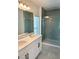 Bright bathroom featuring double sinks, quartz countertops, and a large glass-enclosed shower at 6841 Wilson Hammock Ave, Groveland, FL 34736